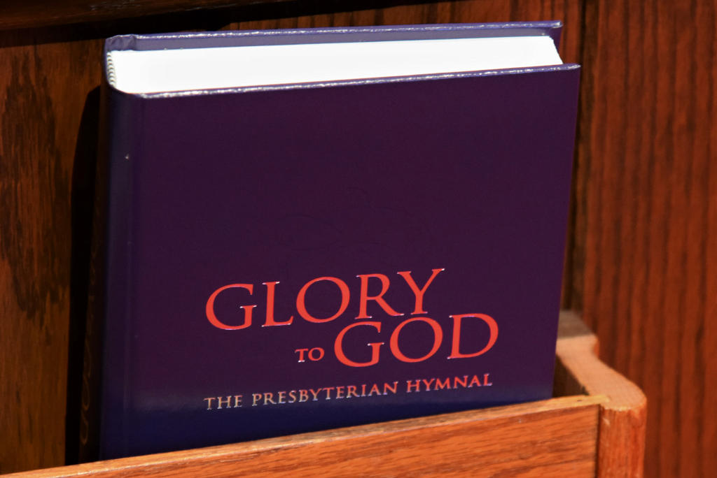 Purple Hymn Book titled "Glory to God The Presbyterian Hymnal."